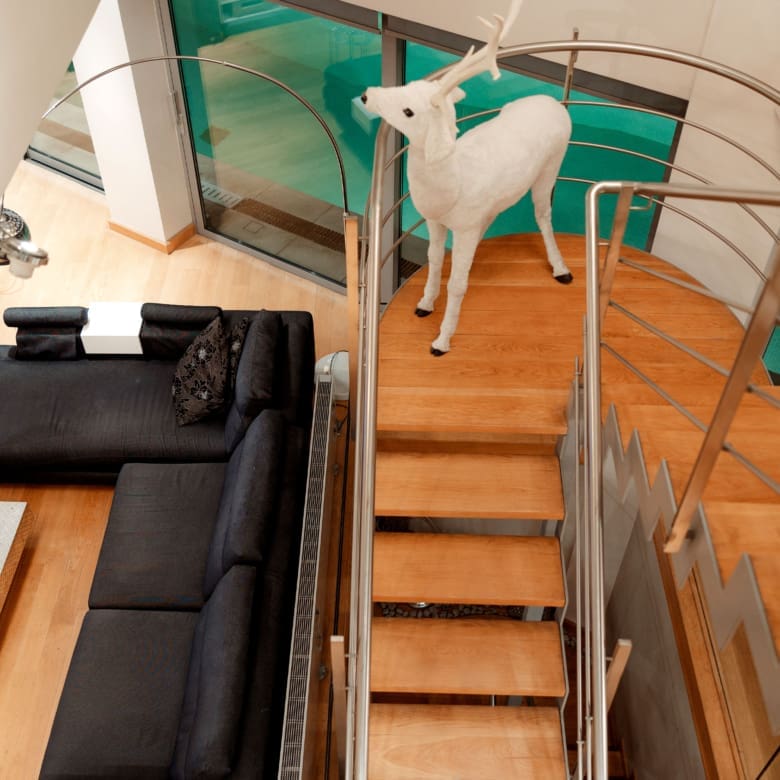 Interior staircase with wood steps and modern railing at a private villa in Alimos, Athens Riviera