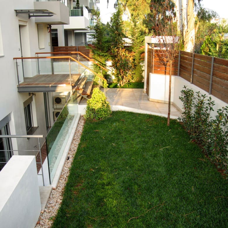 Garden side passage with lawn beside the private villa in Alimos, Athens Riviera