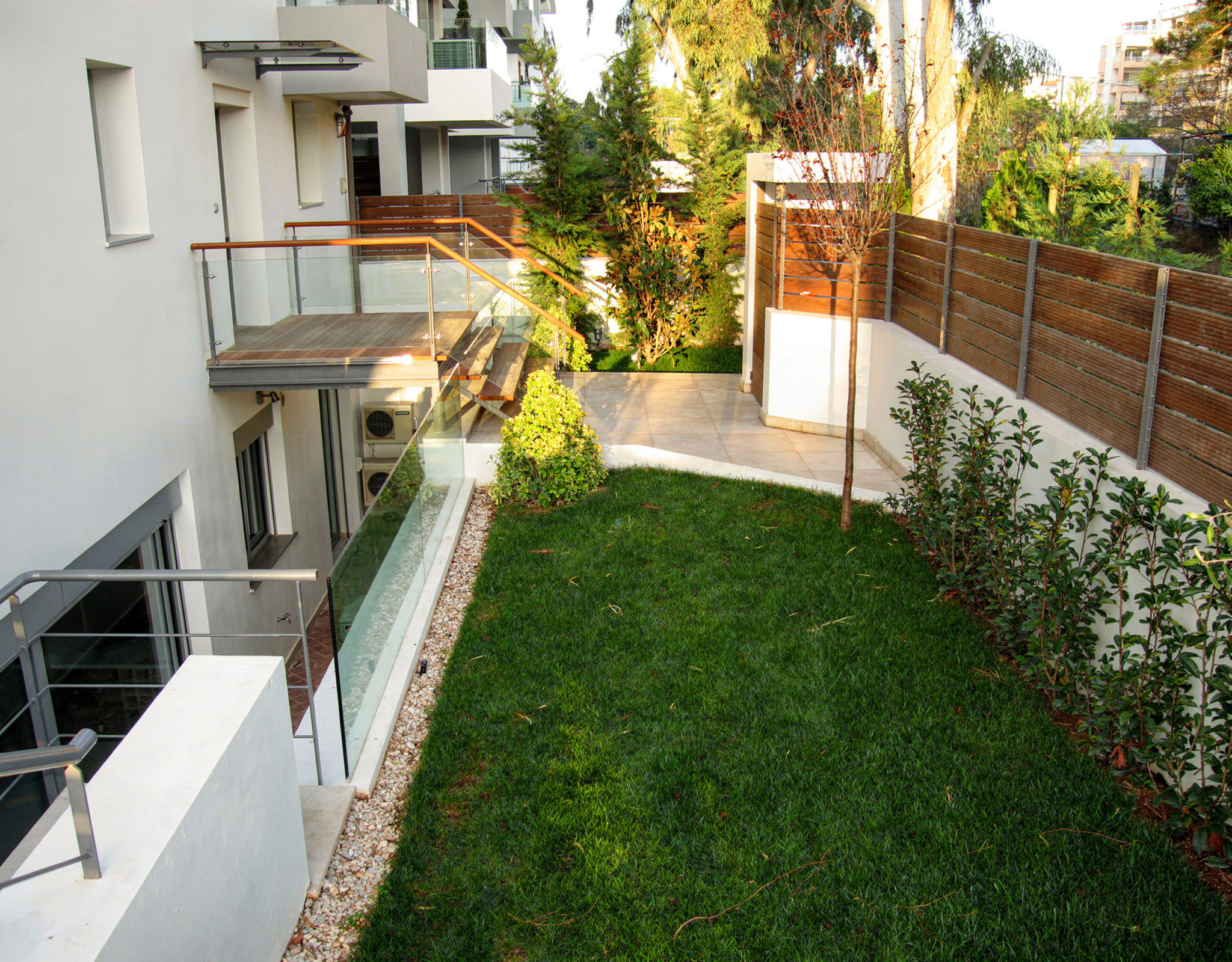 Garden side passage with lawn beside the private villa in Alimos, Athens Riviera