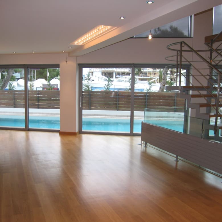 Large open room with sliding doors and pool view at a private villa in Alimos, Athens Riviera