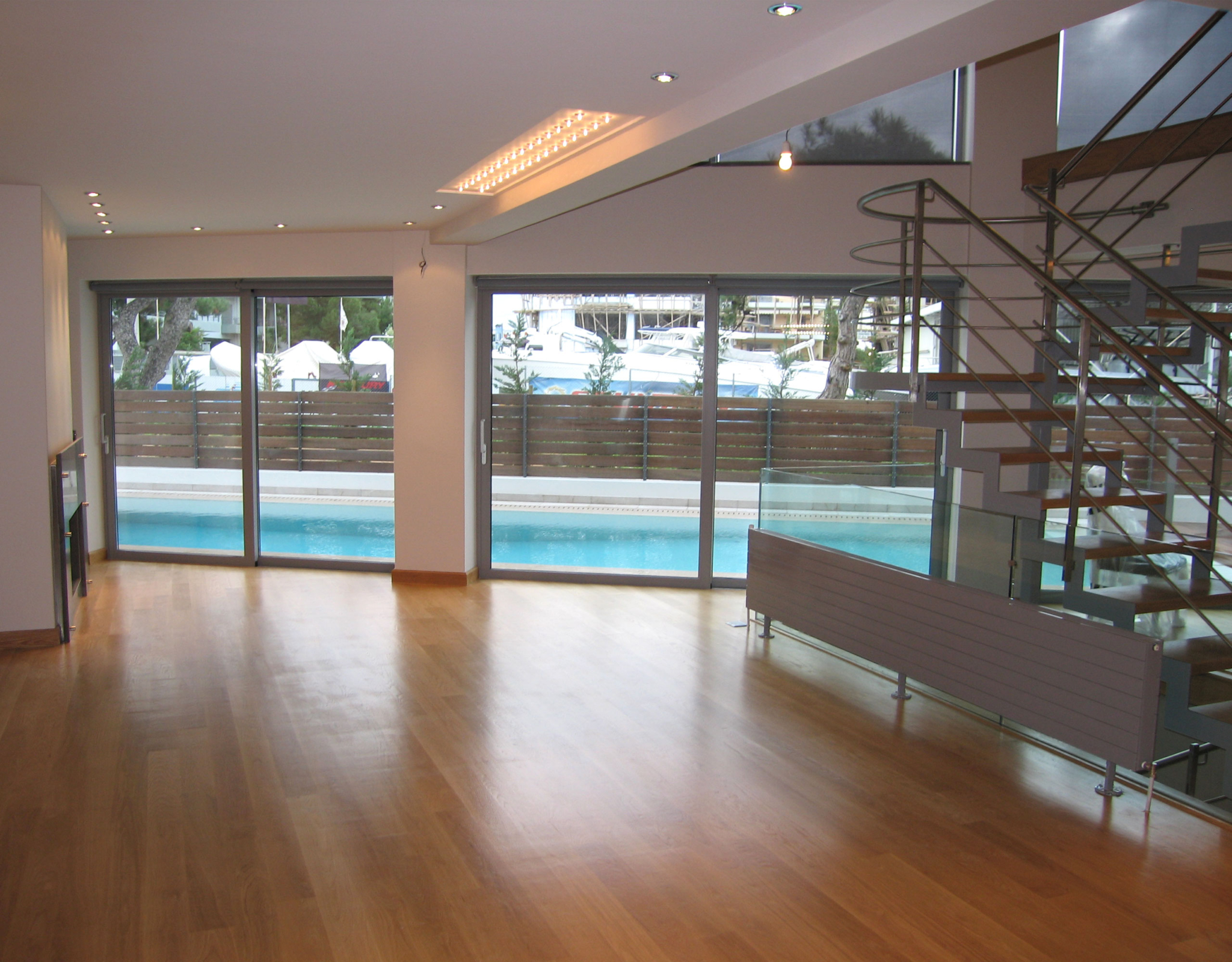 Large open room with sliding doors and pool view at a private villa in Alimos, Athens Riviera