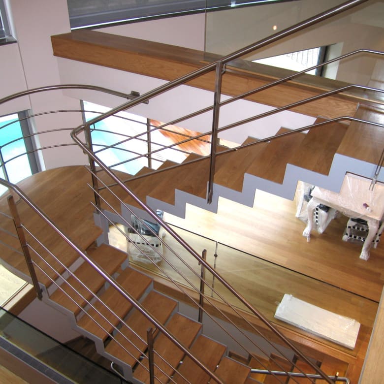 Architectural staircase with mezzanine and open-plan layout at a private villa in Alimos, Athens Riviera