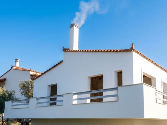 Exterior view of a detached house with white facade and balcony, Dilesi, Boeotia, Greece