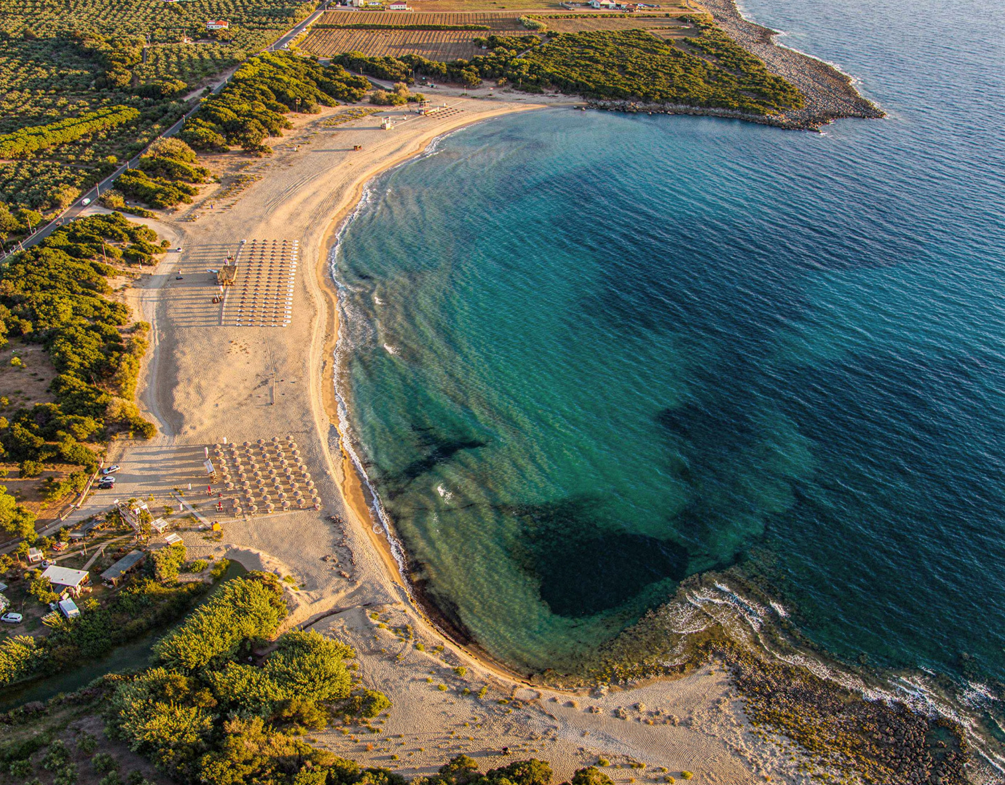 Aerial view of a coastal bay with turquoise water and sandy shoreline, Messinia, Peloponnese, Greece