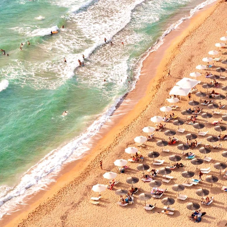Aerial view of sandy beach with sunbeds and clear sea water, Messinia, Peloponnese, Greece