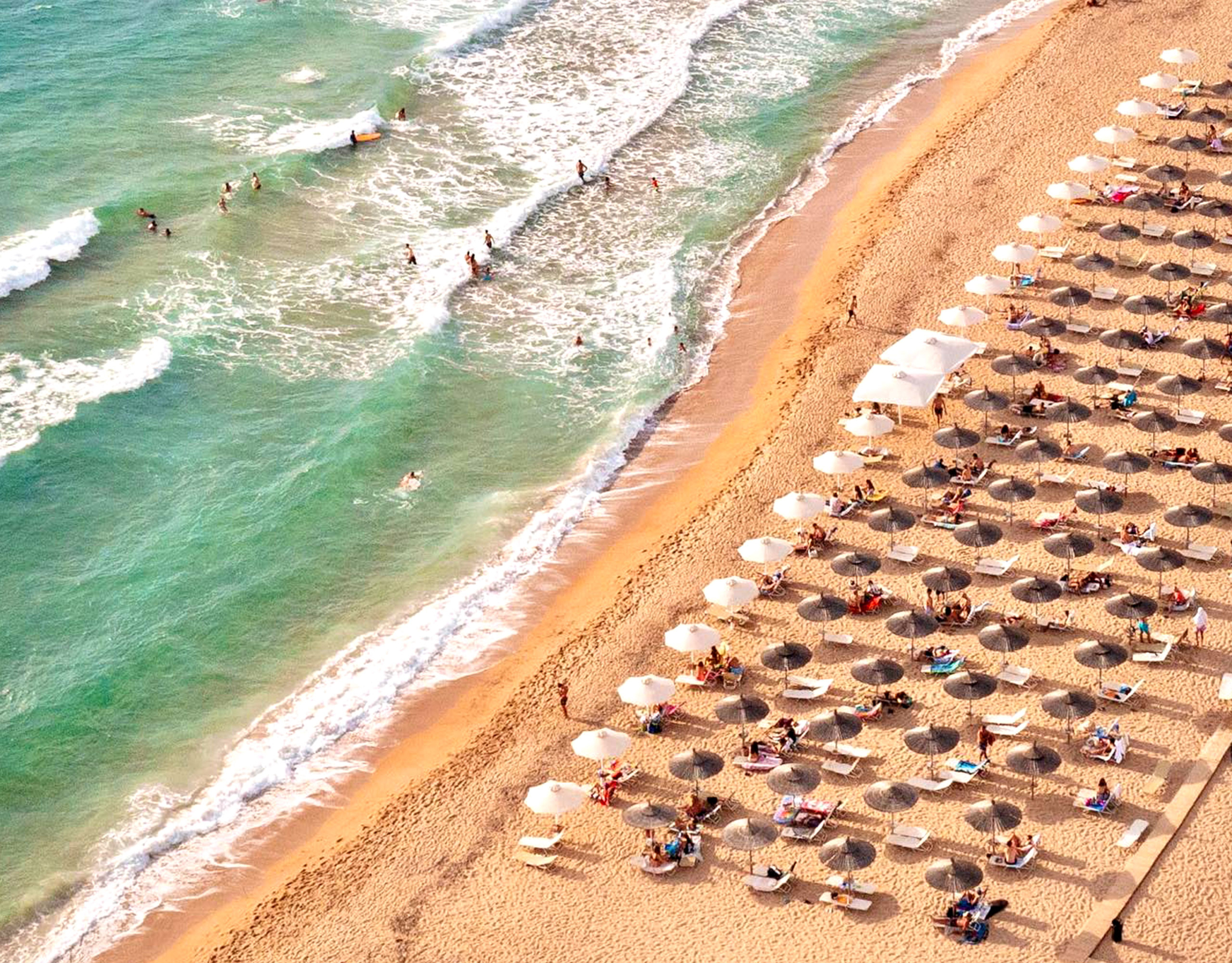 Aerial view of sandy beach with sunbeds and clear sea water, Messinia, Peloponnese, Greece