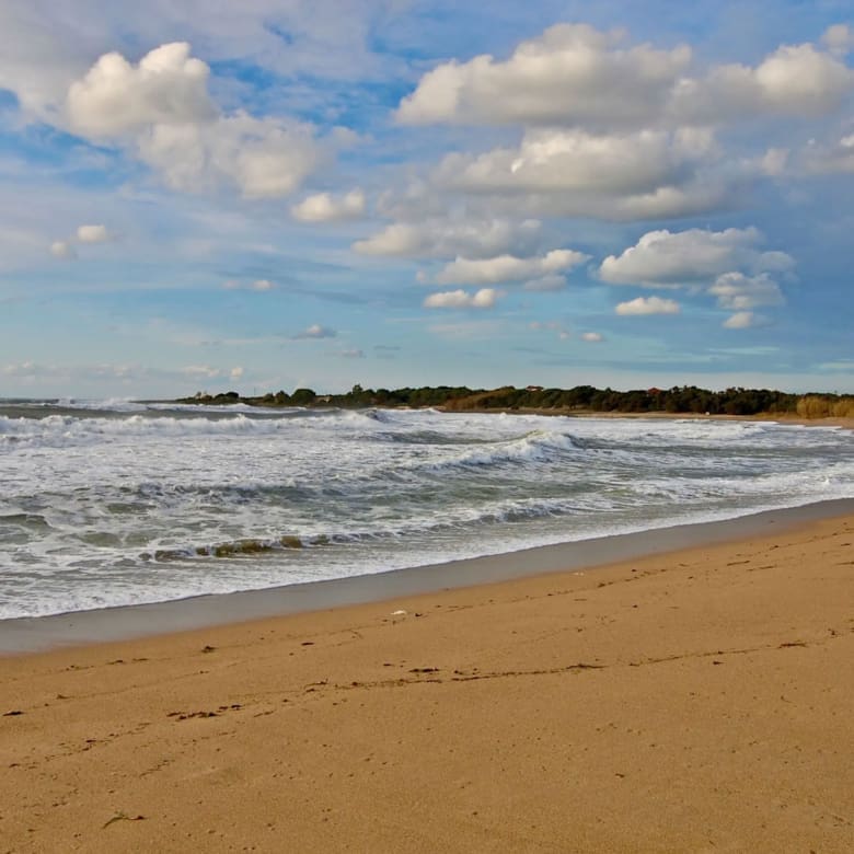 Sandy beach with sea waves and open sky, Messinia, Peloponnese, Greece