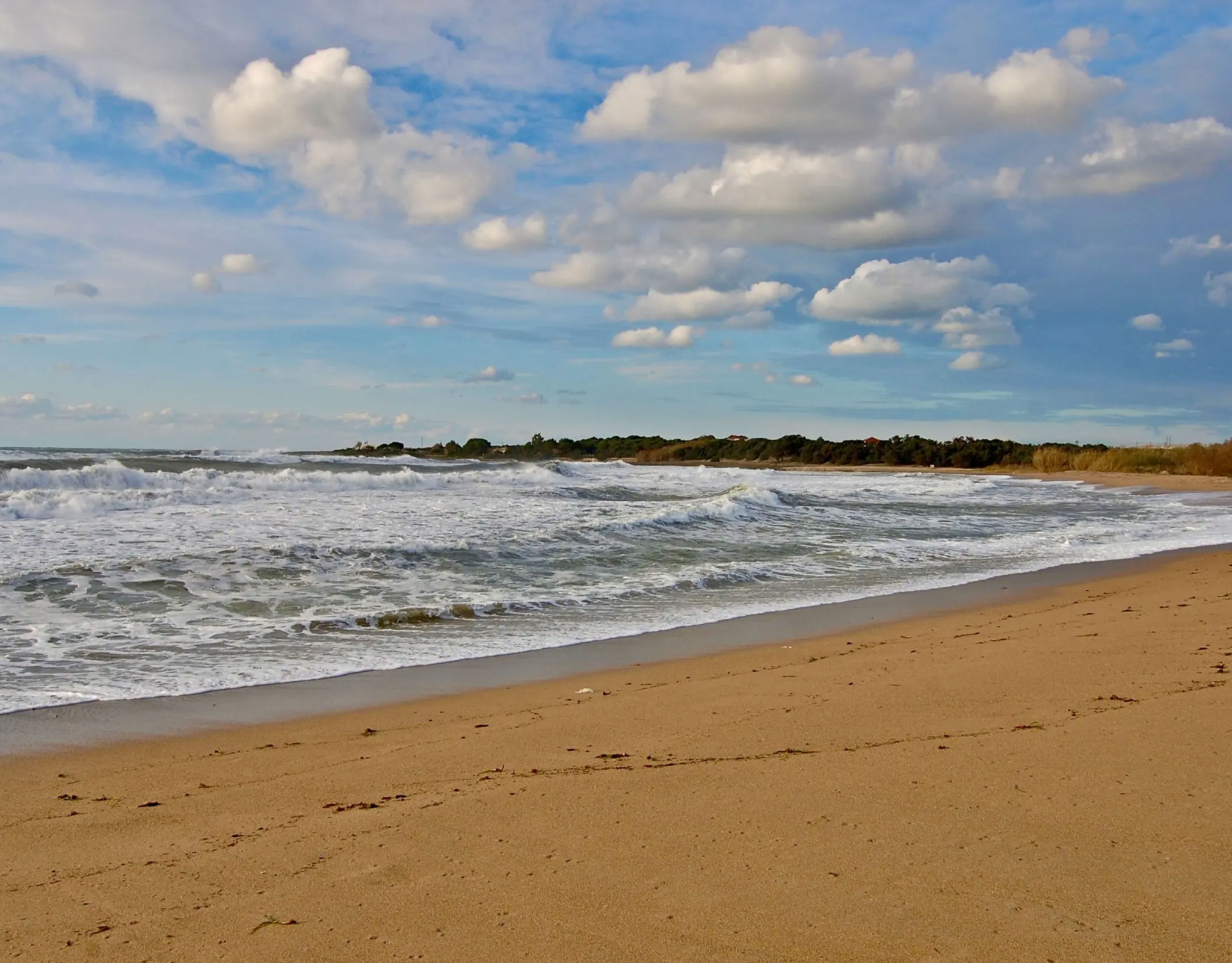 Sandy beach with sea waves and open sky, Messinia, Peloponnese, Greece