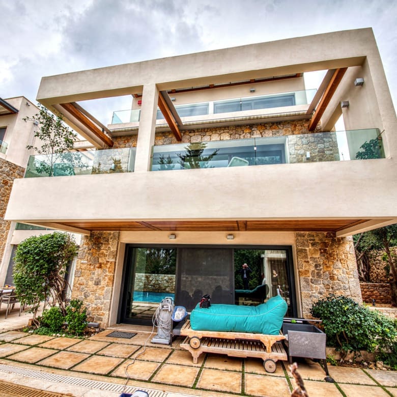 Exterior facade with balconies and covered outdoor seating area, Porto Rafti, Greece