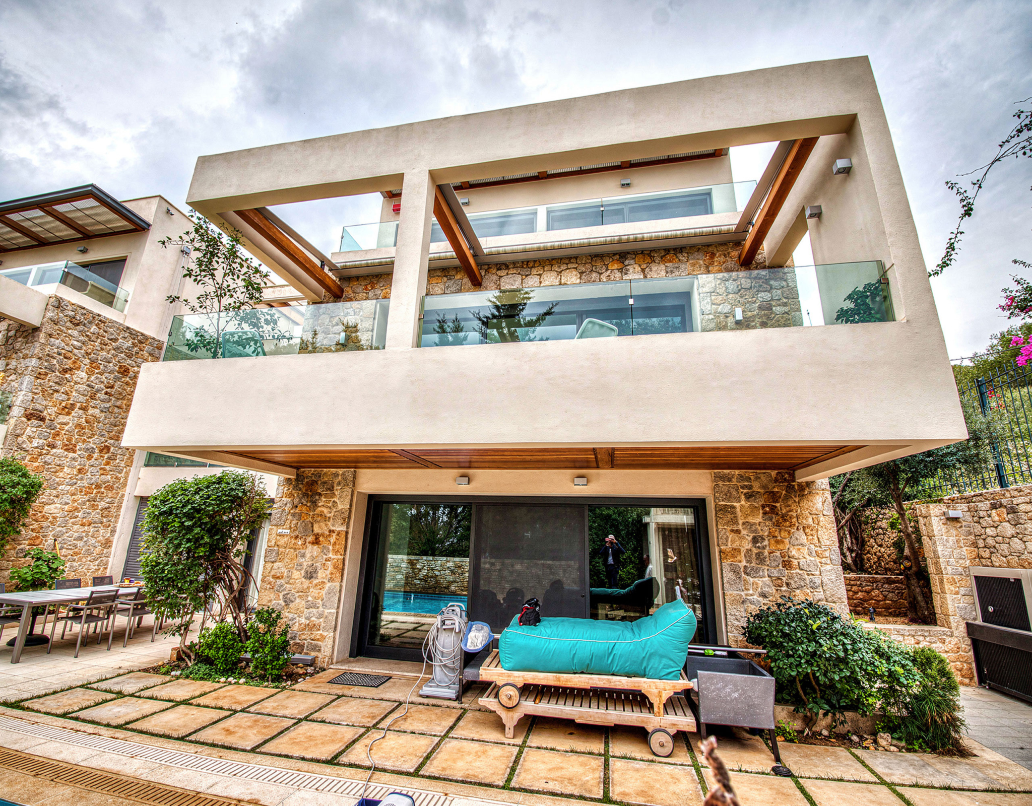Exterior facade with balconies and covered outdoor seating area, Porto Rafti, Greece