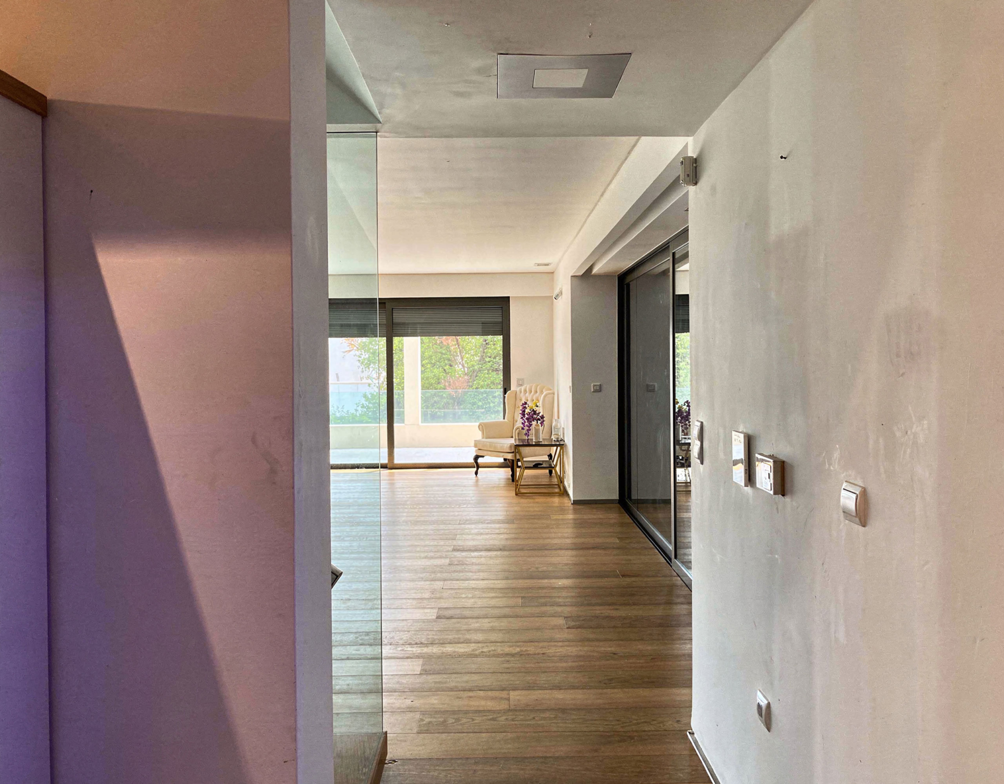 Interior hallway with wood flooring and view toward the living area, Porto Rafti, Greece