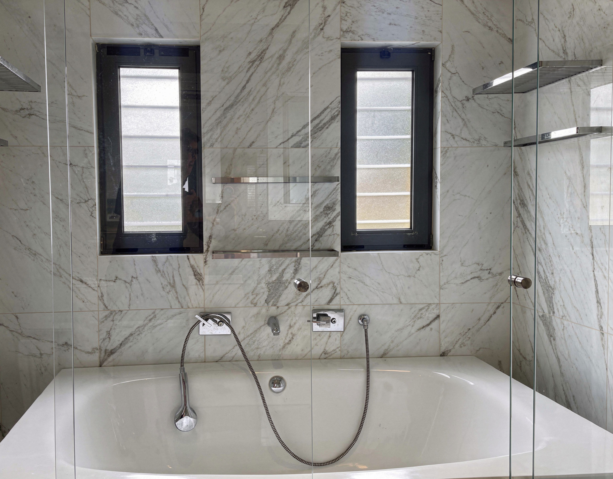 Bathroom with bathtub, marble-look wall tiles, and window, Porto Rafti, Greece