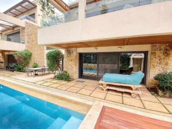 Poolside area with wooden deck, outdoor seating, and covered patio, Porto Rafti, Greece
