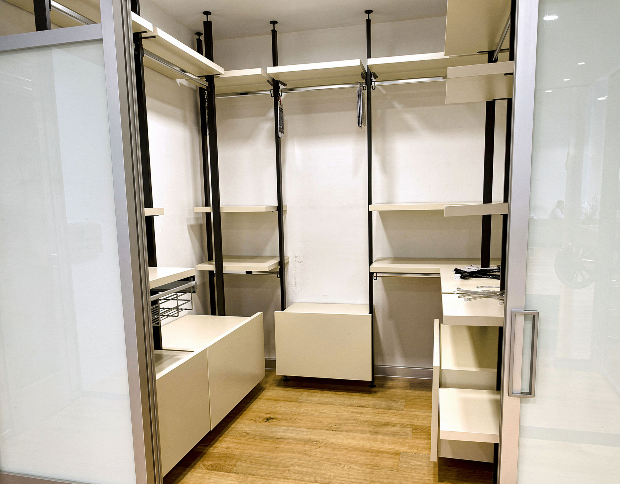 Walk-in closet with open shelving, hanging rails, and wood flooring, Porto Rafti, Greece