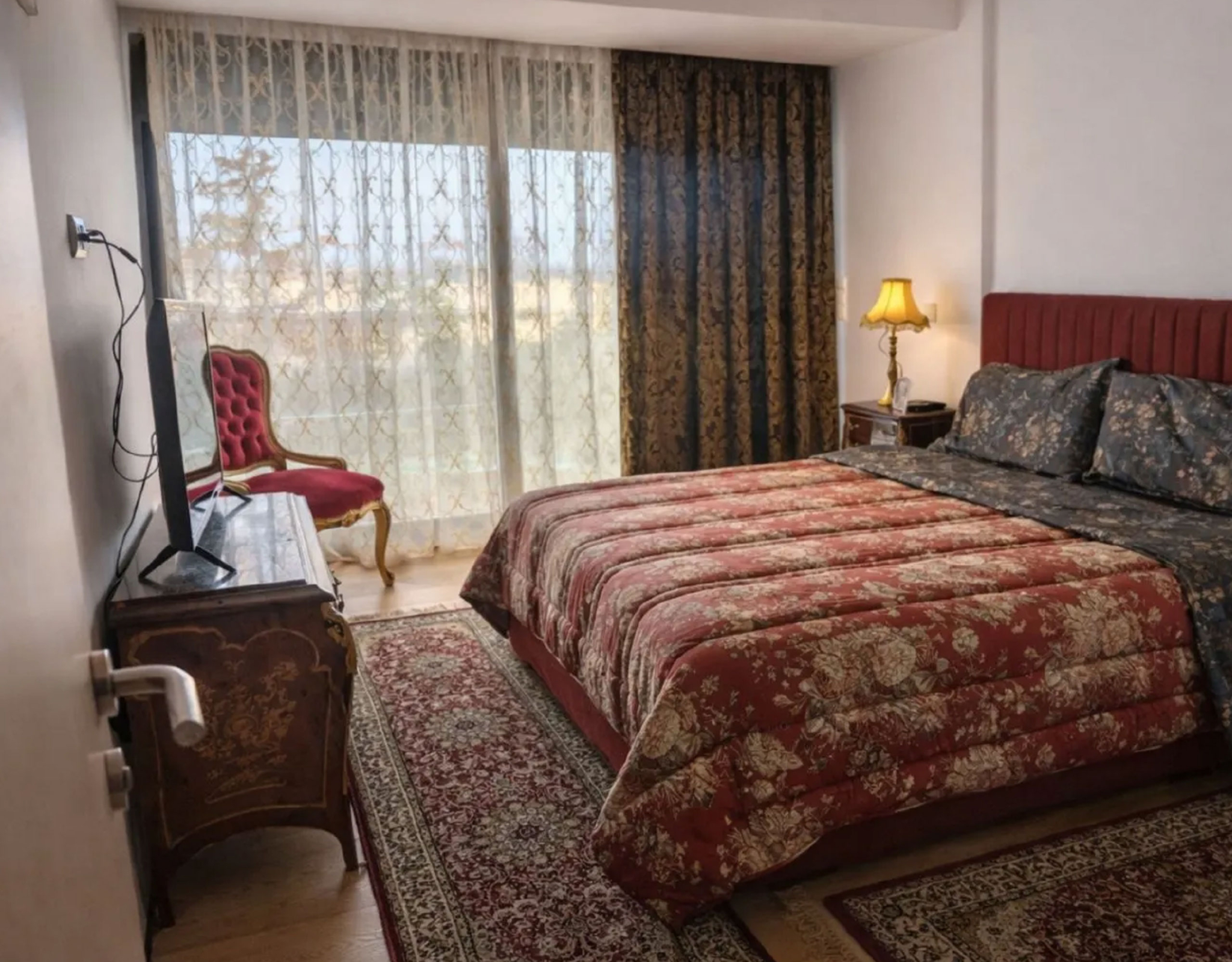 Bedroom with double bed, curtains, and warm interior lighting, Porto Rafti, Greece