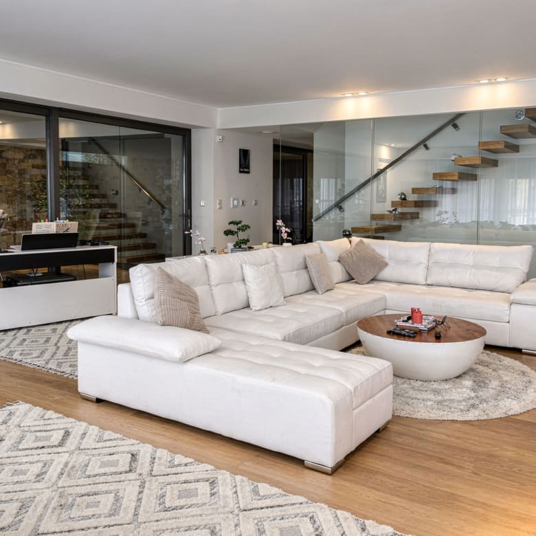 Modern living room with large sectional sofa and open-plan layout, Porto Rafti, Greece