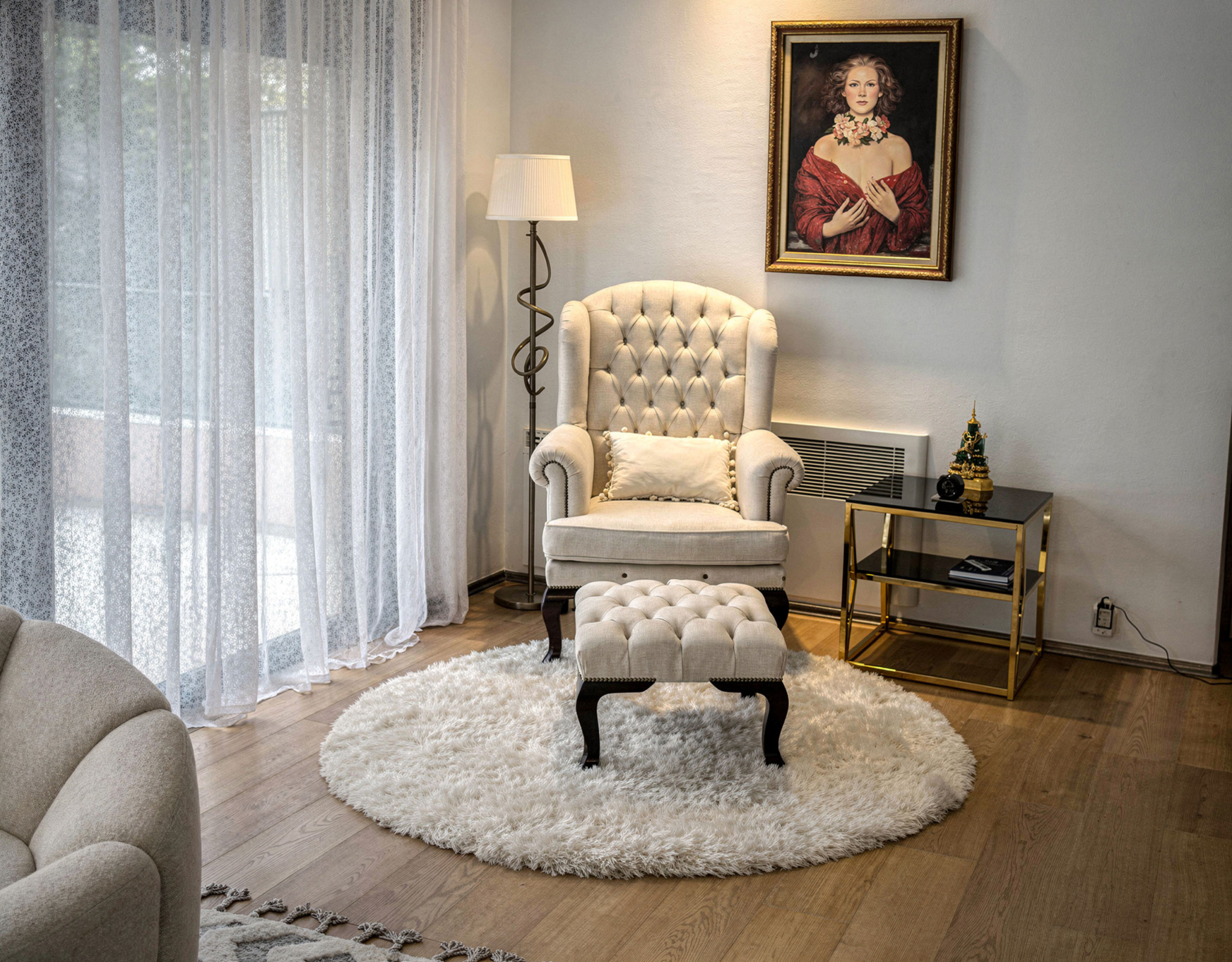 Sitting area with armchair, side table, and soft daylight through curtains, Porto Rafti, Greece