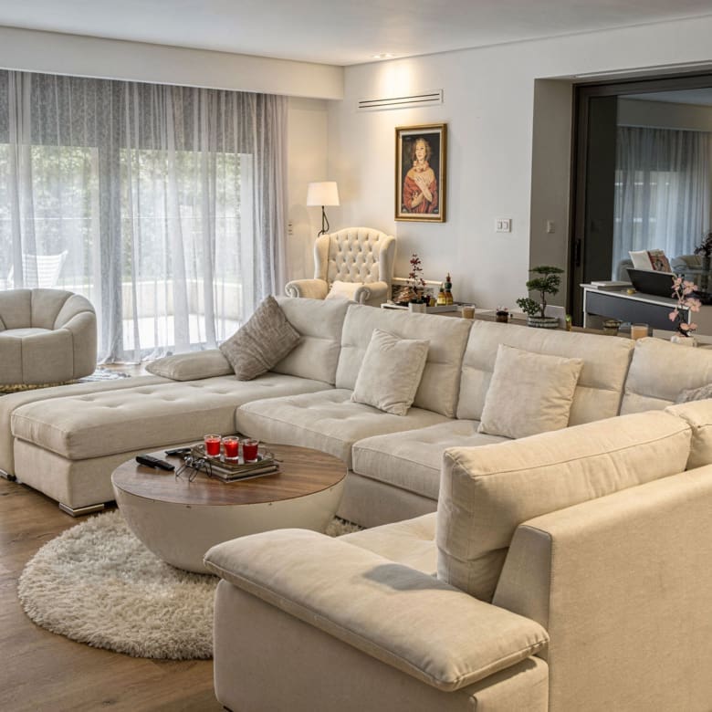 Living room with sectional sofa, coffee table, and soft ambient lighting, Porto Rafti, Greece