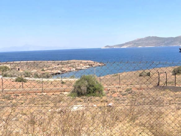 Sea view over dry coastal terrain with distant islands, Greece