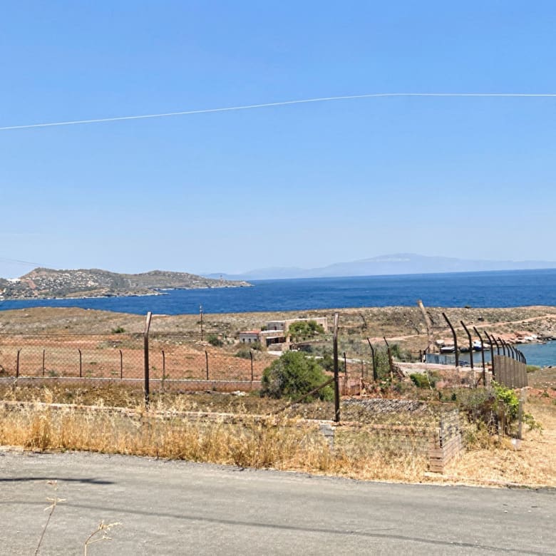 Coastal land view with fencing and sea horizon, Greece