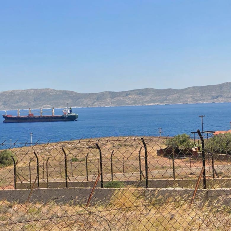 Coastal sea view with passing ship and distant mountains, Greece