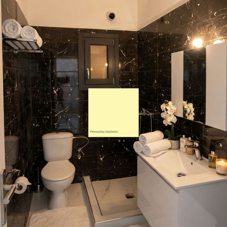 Modern bathroom with dark marble finishes in the Exo Gonia apartment, Santorini