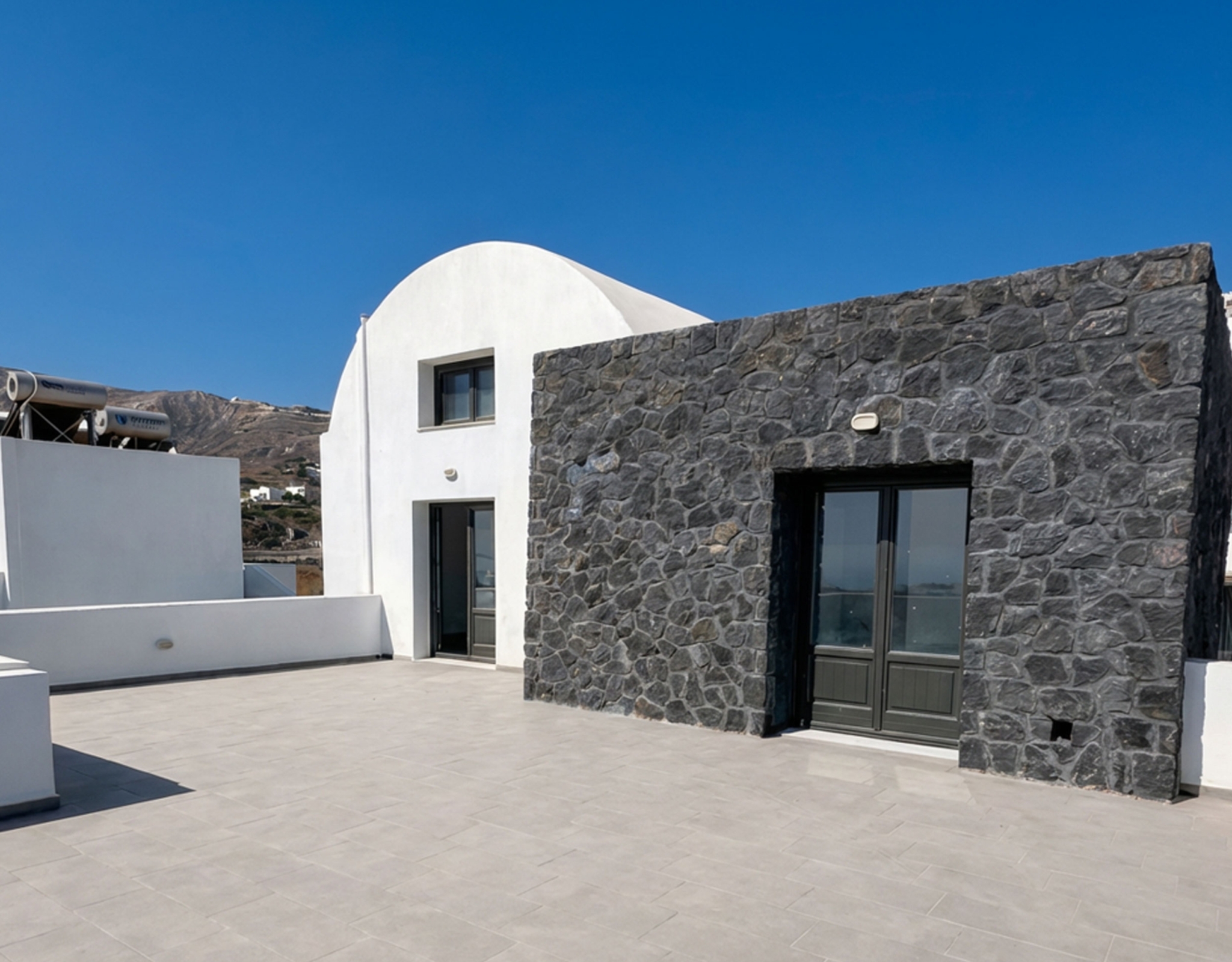 Exterior view of Santorini sea-view apartment in Exo Gonia with Cycladic architecture