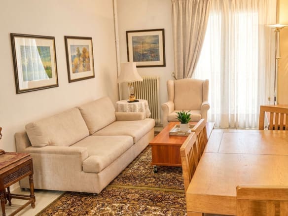 Living room with sofa, coffee table, and balcony door, Athens City Center, Greece