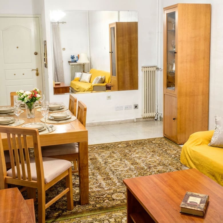 Open-plan living and dining area with sofa and dining table, Athens City Center, Greece