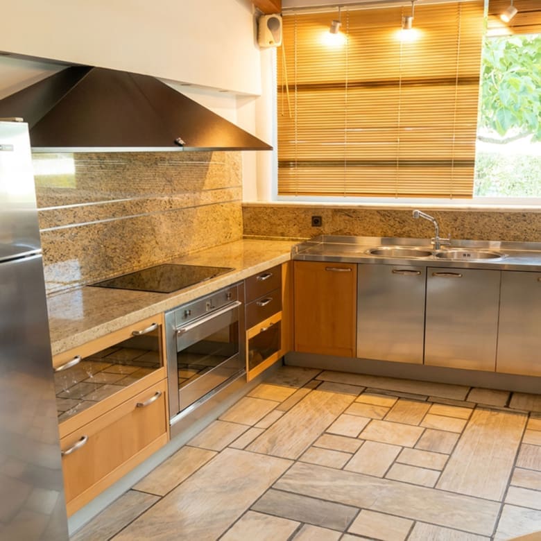 Kitchen with built-in cabinetry and tiled finishes at a private estate in Porto Rafti, Attica