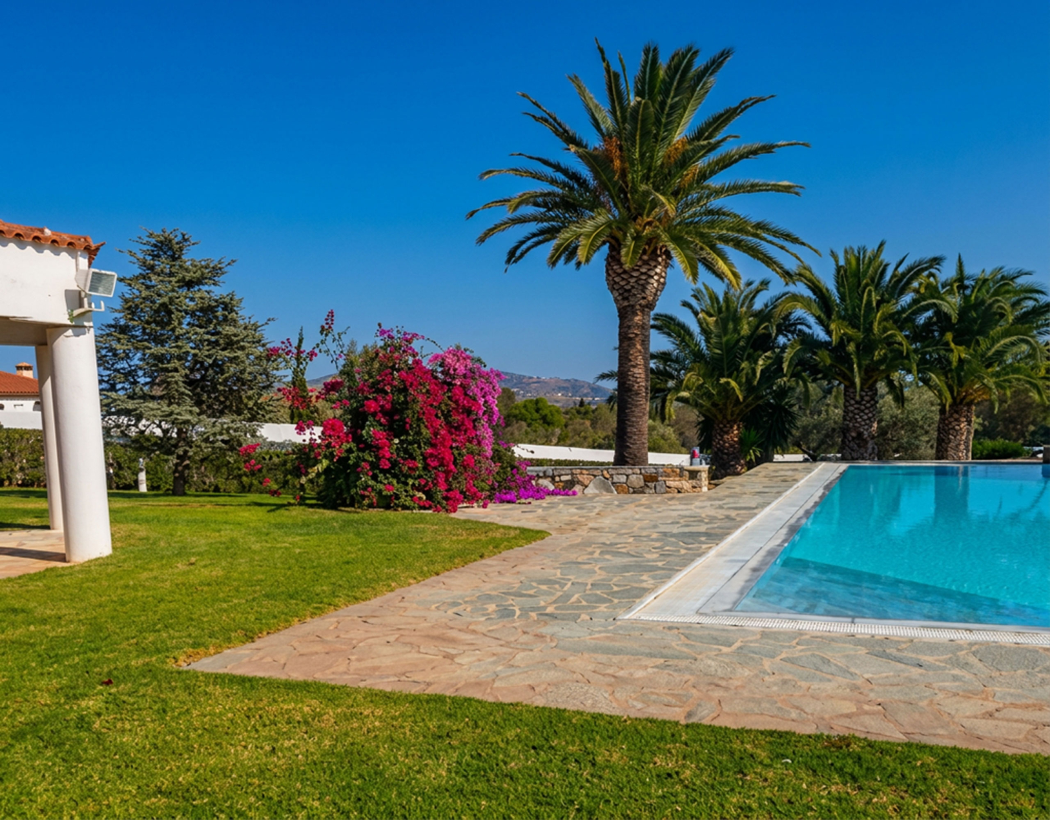 Porto Rafti Estate – Garden Lawn & Poolside View Garden lawn and poolside view at a private estate in Porto Rafti, Attica