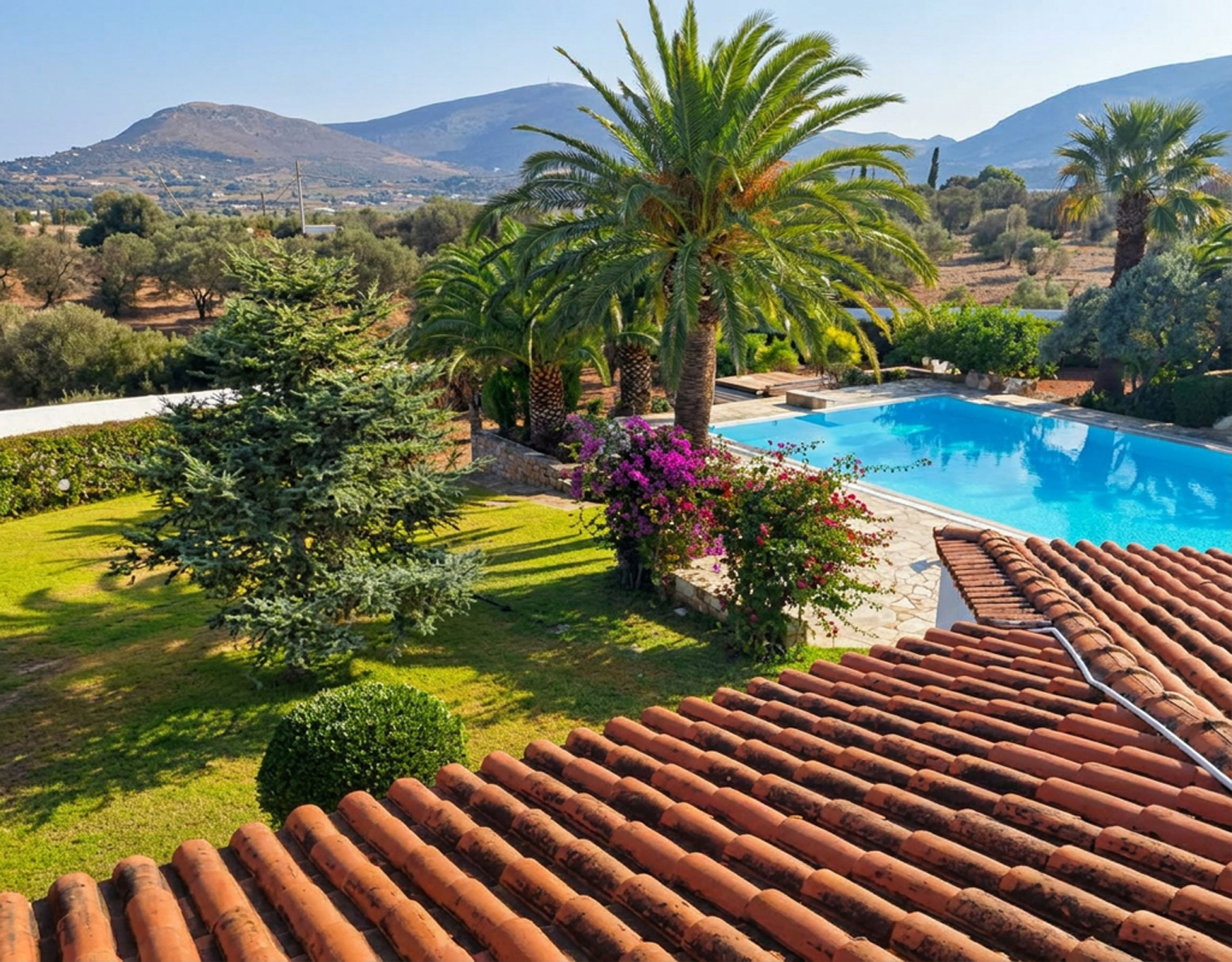 Porto Rafti Estate – Elevated Pool & Garden View Elevated view over the swimming pool and landscaped garden at a private estate in Porto Rafti, Attica