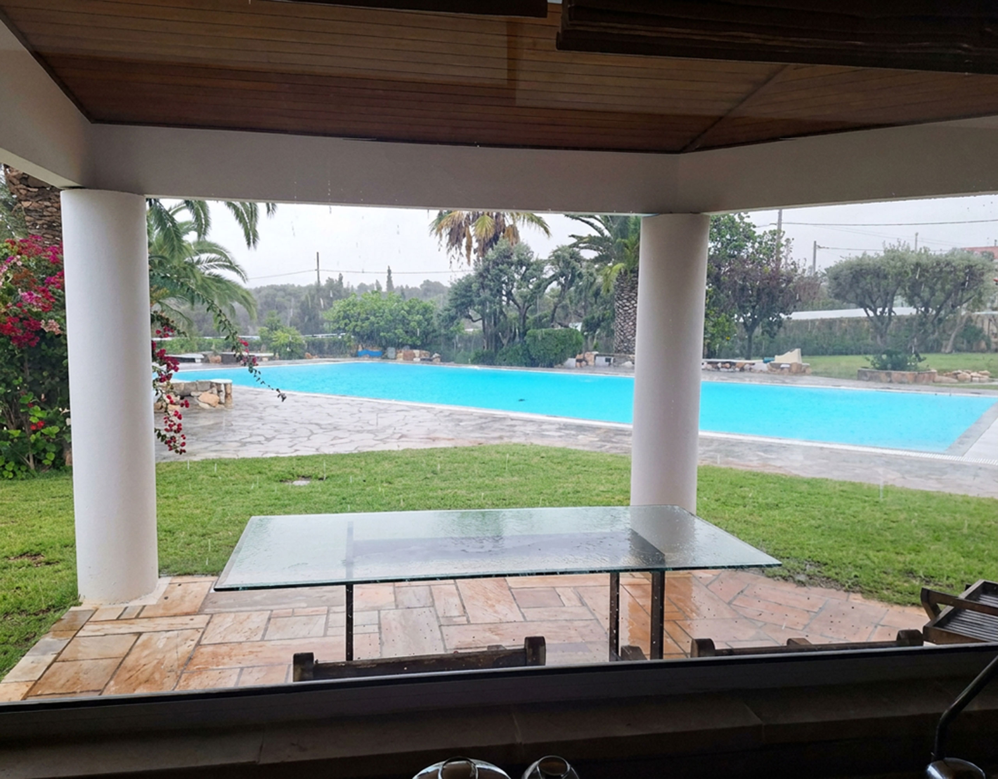 Porto Rafti Estate – Covered Terrace Facing the Pool Covered terrace looking out to the swimming pool and garden at a private estate in Porto Rafti, Attica