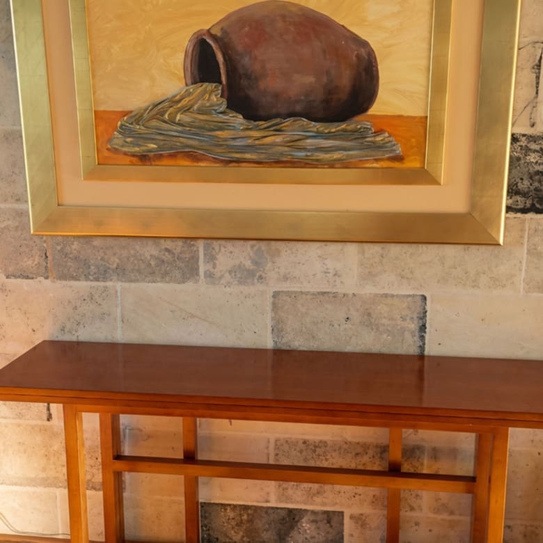 Wood console table with framed artwork in the Porto Rafti private estate interior