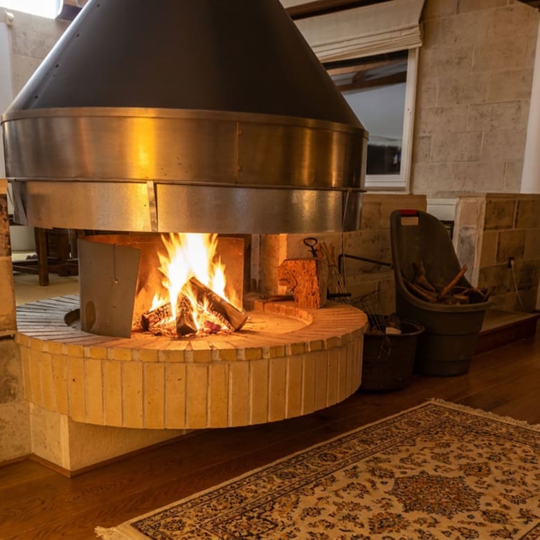 Fireplace with active fire in the Porto Rafti private estate interior