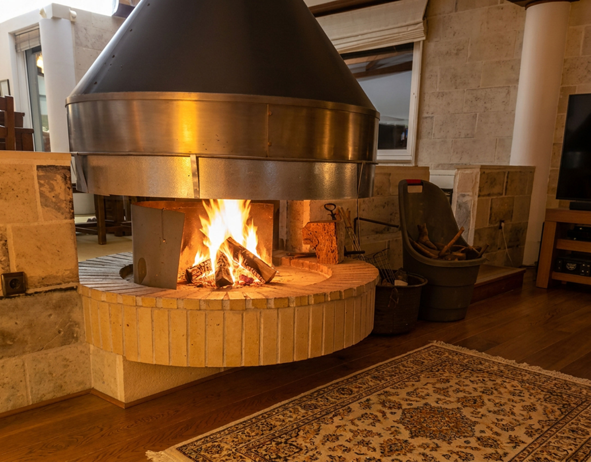 Porto Rafti Estate – Fireplace with Active Fire Fireplace with active fire in the Porto Rafti private estate interior