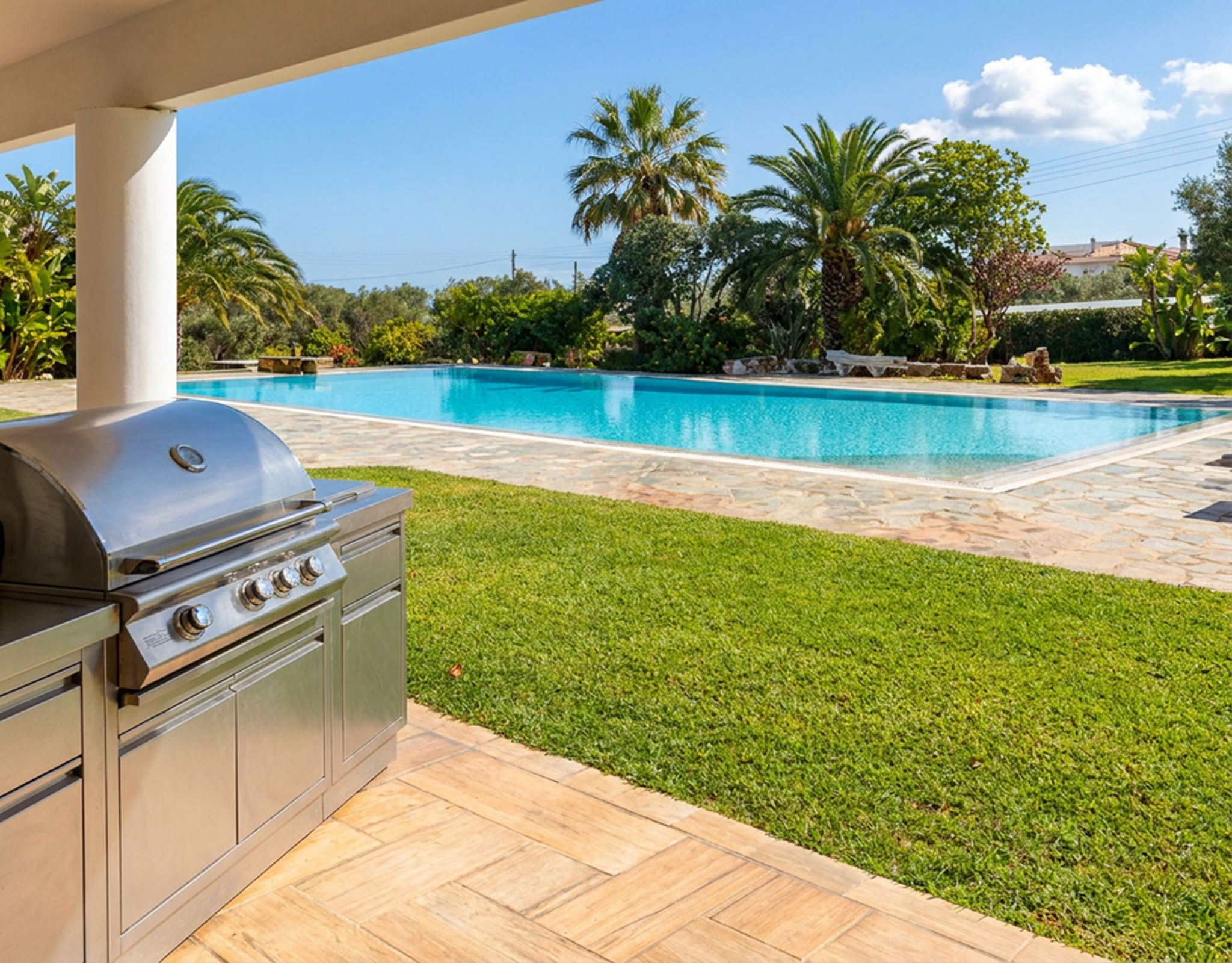 Porto Rafti Estate – BBQ Terrace by the Pool Outdoor barbecue terrace with pool and garden view at a private estate in Porto Rafti, Attica