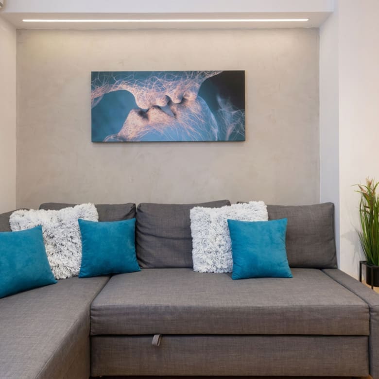 Living room sofa with decorative pillows and wall art, Nea Filothei, Athens, Greece