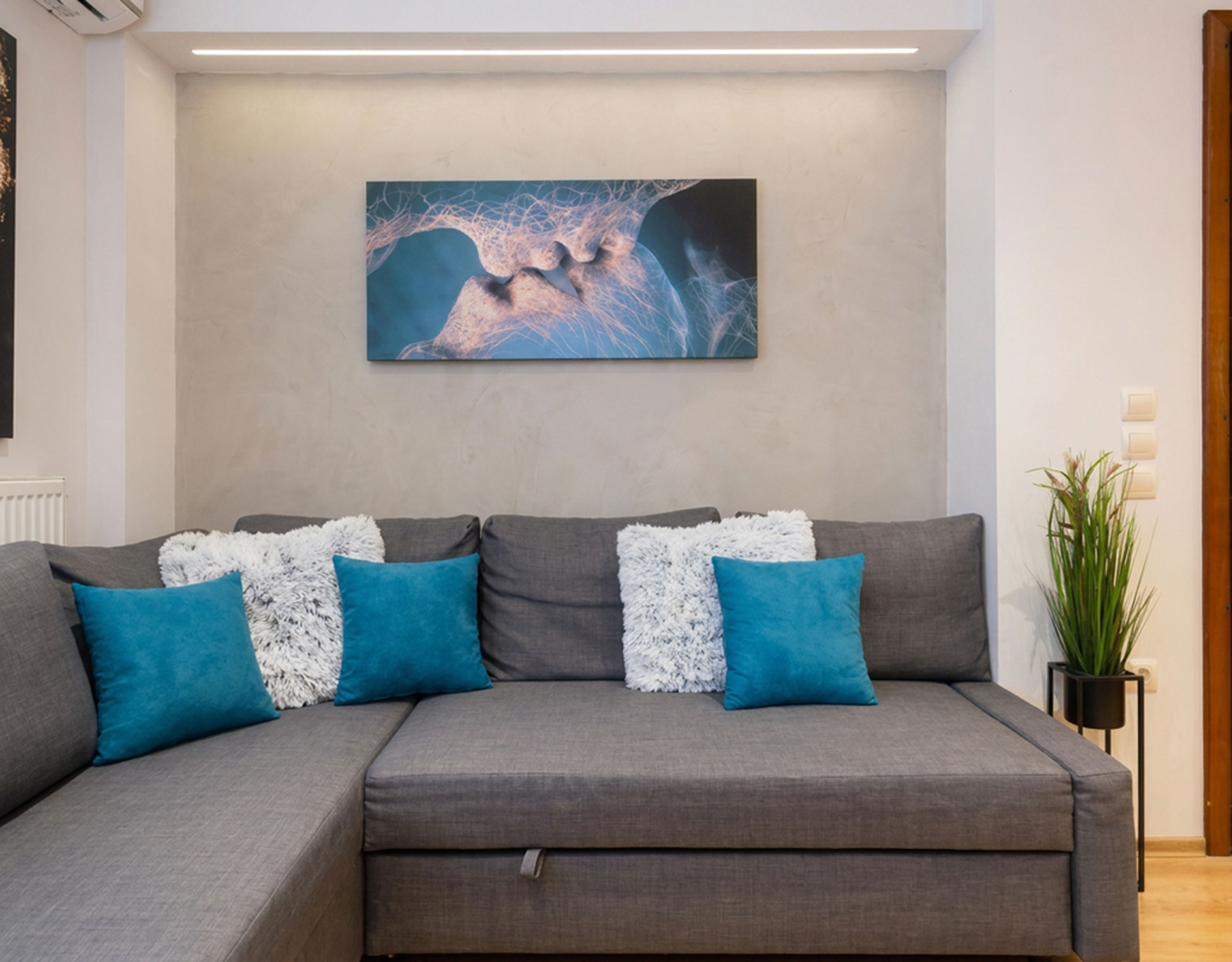 Living room sofa with decorative pillows and wall art, Nea Filothei, Athens, Greece