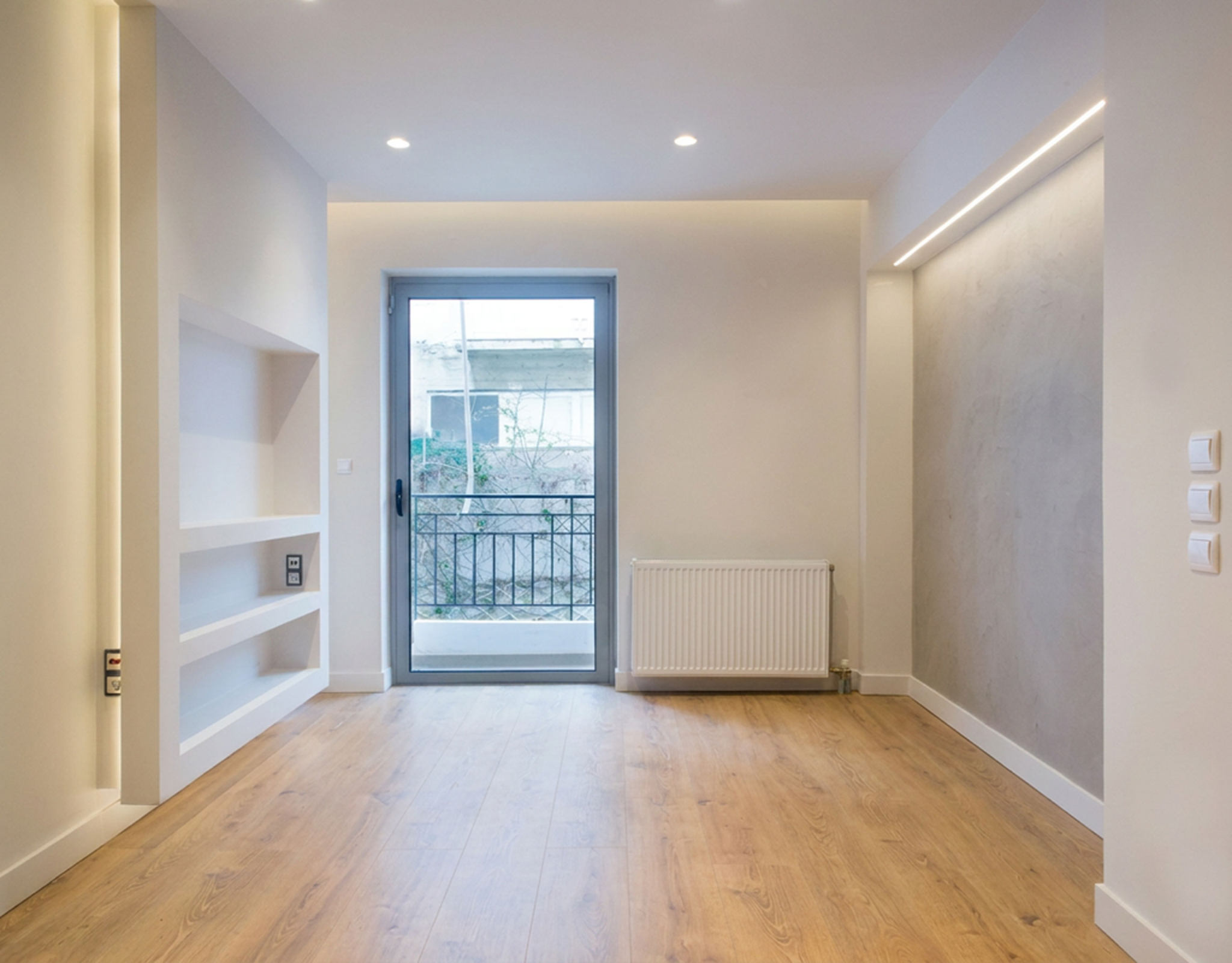 Bright empty room with wood flooring and balcony door, Nea Filothei, Athens, Greece