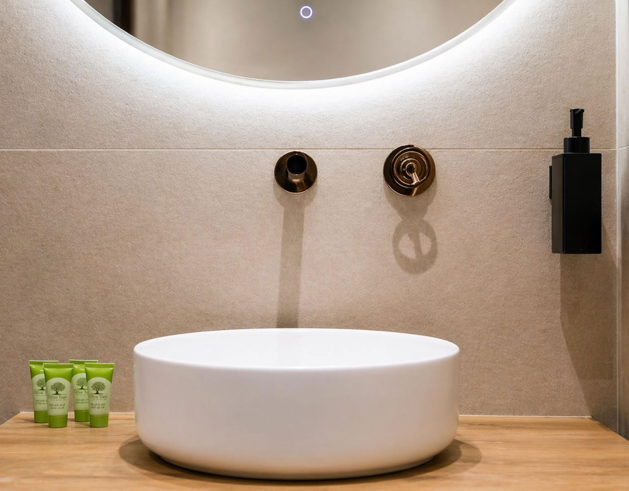Bathroom basin sink detail with round mirror and soft backlighting, Nea Filothei, Athens, Greece