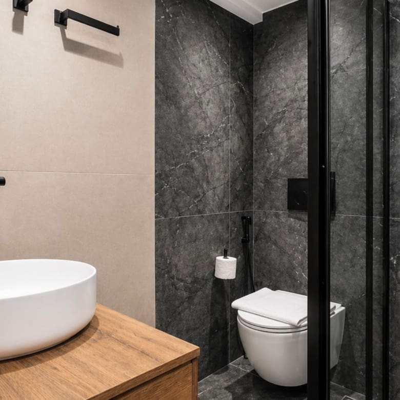 Bathroom with vanity, toilet, and dark stone-look shower enclosure, Nea Filothei, Athens, Greece