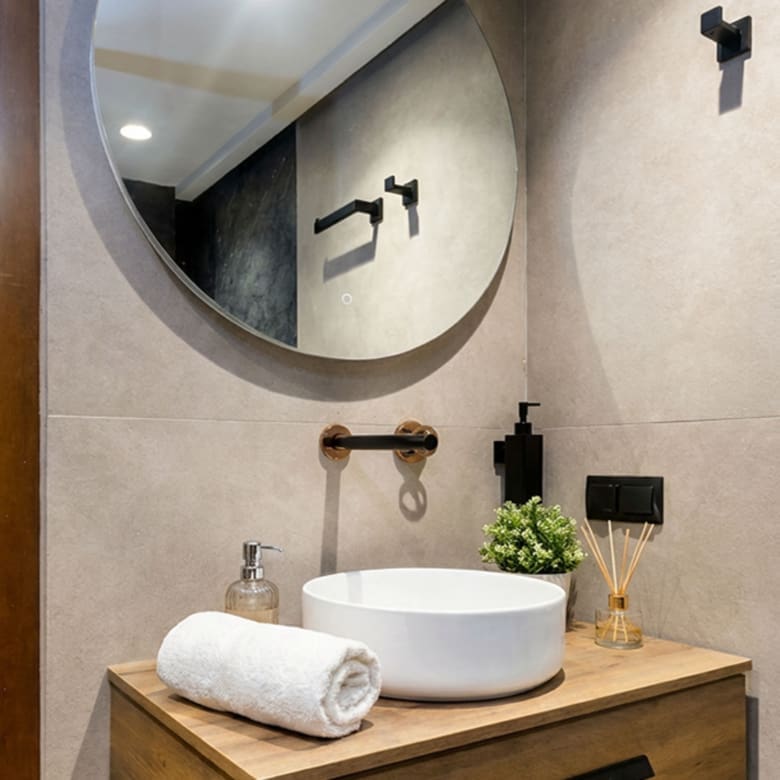 Bathroom vanity with round mirror, wood cabinet, and modern basin, Nea Filothei, Athens, Greece