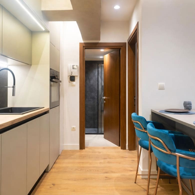 Open-plan kitchen and dining area with island seating and wood flooring, Nea Filothei, Athens, Greece