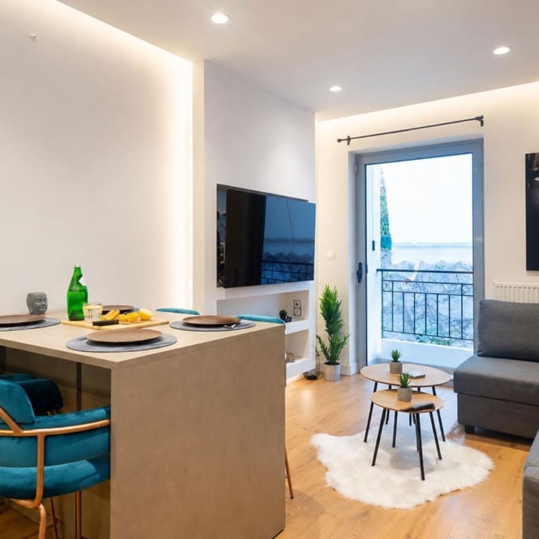 Living room with sofa, kitchen island seating, and balcony access, Nea Filothei, Athens, Greece