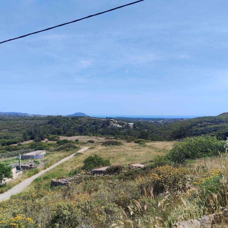 Wide landscape view with access road and distant sea horizon, Kythira, Greece