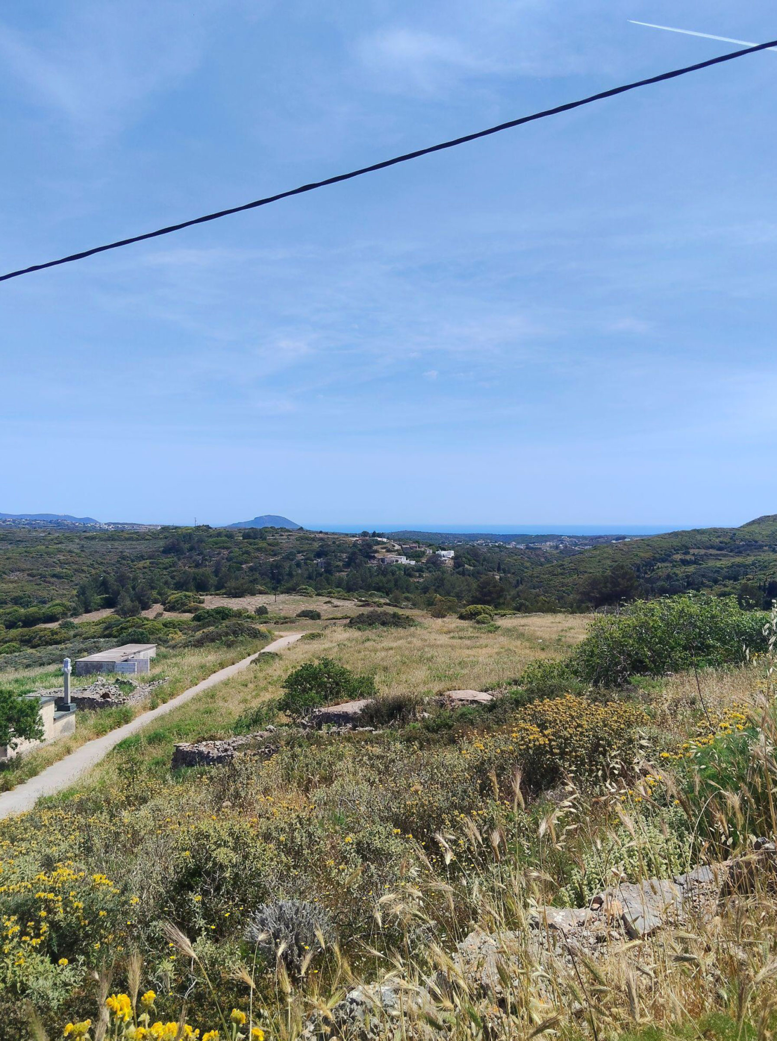Wide landscape view with access road and distant sea horizon, Kythira, Greece