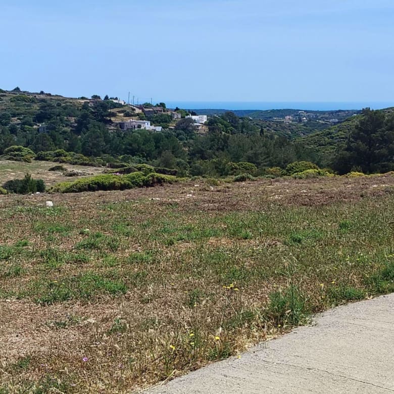 Access road view with open landscape and distant sea view, Kythira, Greece