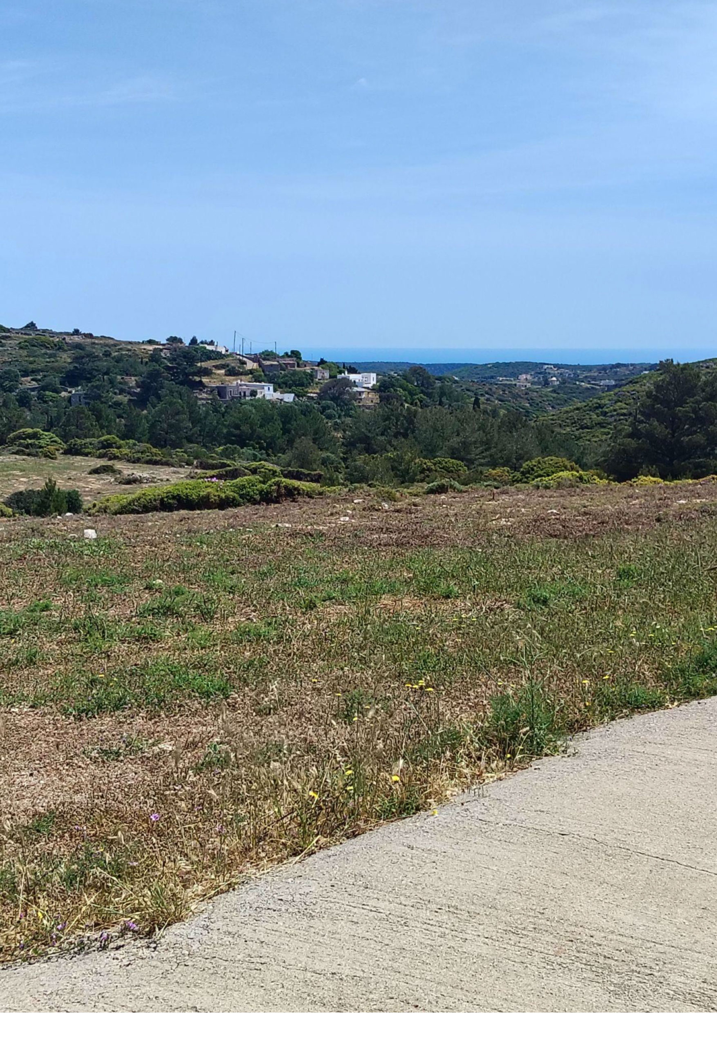Access road view with open landscape and distant sea view, Kythira, Greece