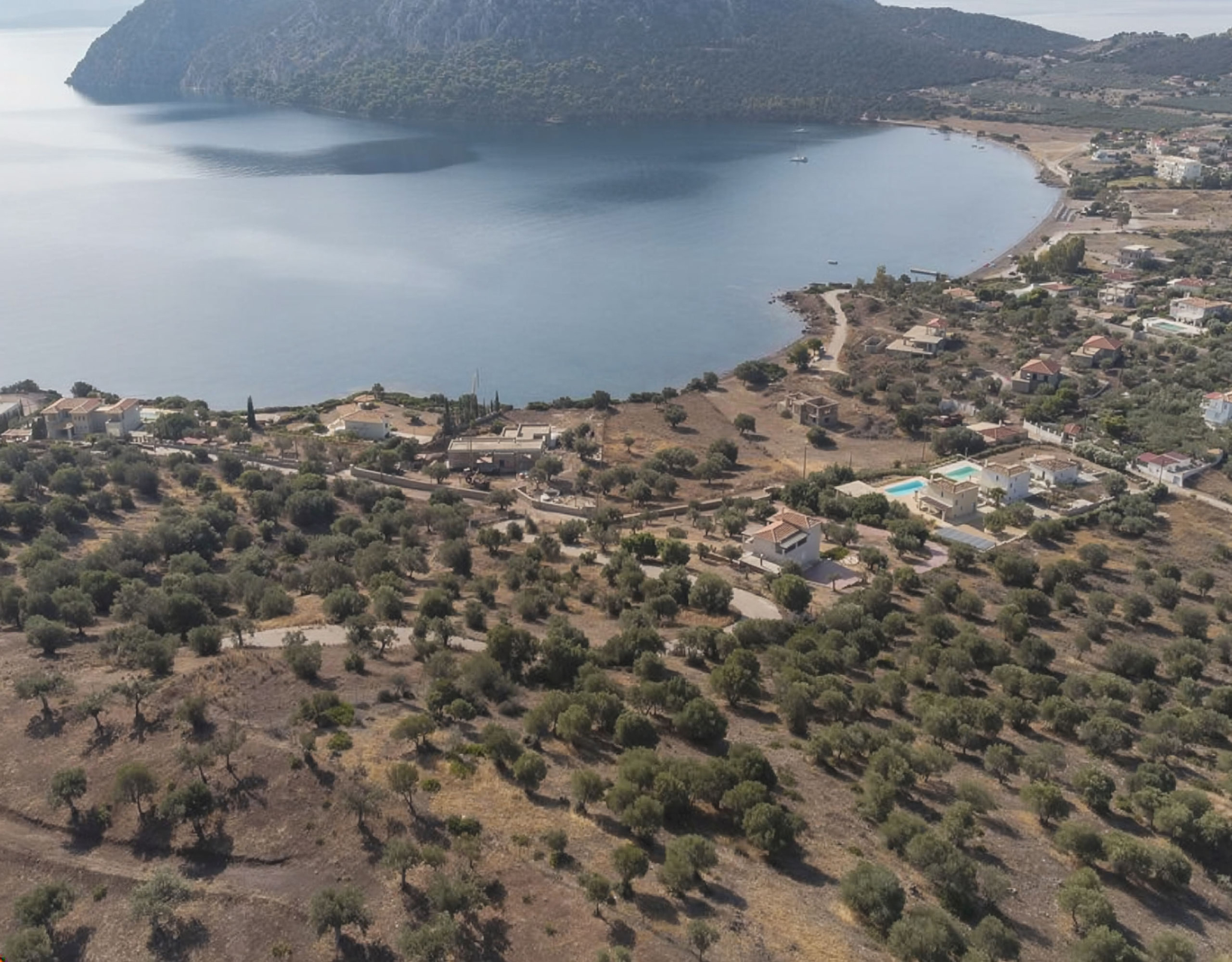 Ermioni Seaview Land Plot – Aerial View Of Coastal Bay Aerial view of a coastal bay and surrounding landscape, Ermioni, Greece